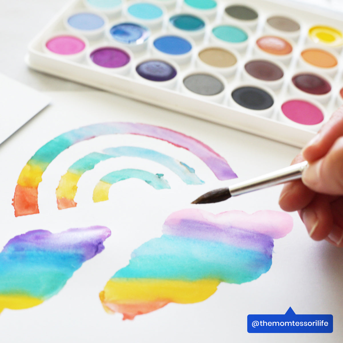 Close up of painted rainbow and clouds from OOLY Lil Watercolor Paint Pods