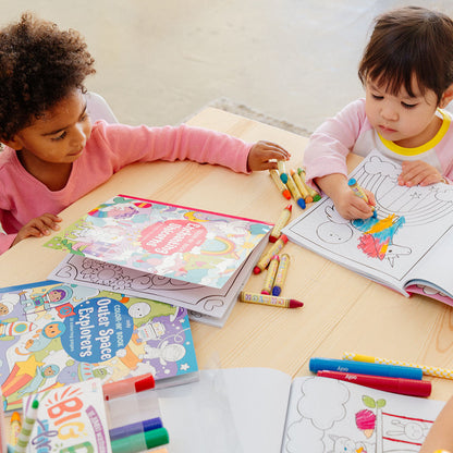 2 kids coloring in an Enchanting Unicorns Coloring Book