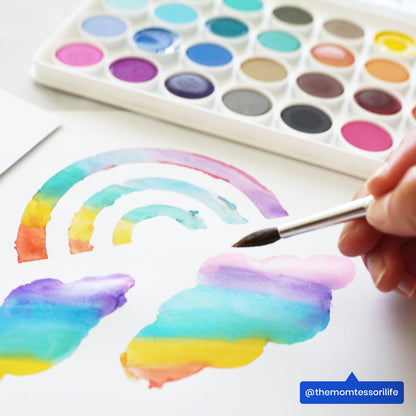 Close up of painted rainbow and clouds from OOLY Lil Watercolor Paint Pods