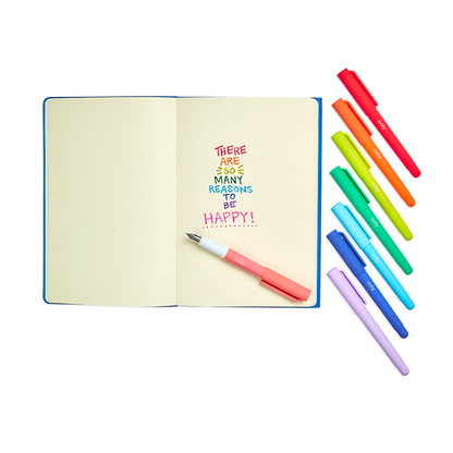 Color Write Fountain Pens set of 8 shown with a notebook and writing