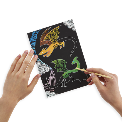 Close up of fantastic dragons being revealed from a Scratch and Scribble scratch art kit