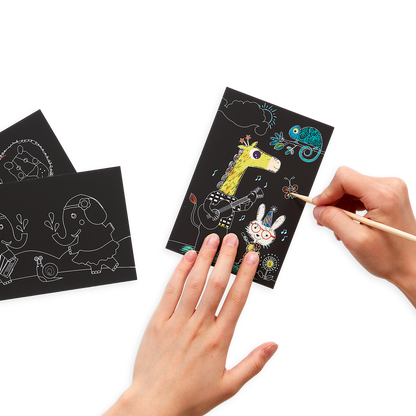 Hands drawing on the Safari Party Scratch and Scribble Mini Scratch Art Kit