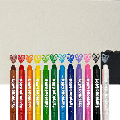 Row of OOLY Body Doodlers - Face & Body Crayons against background and colored heart swatches