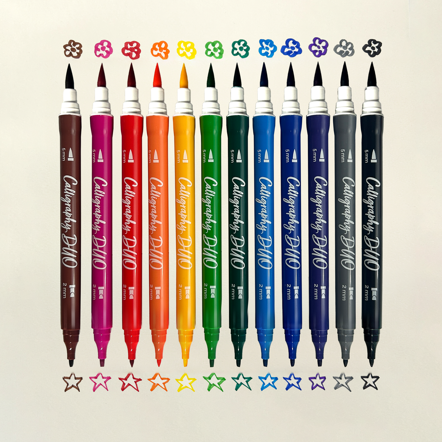 Row of OOLY Calligraphy Duo Double-Ended Markers with chisel and brush tip swatches