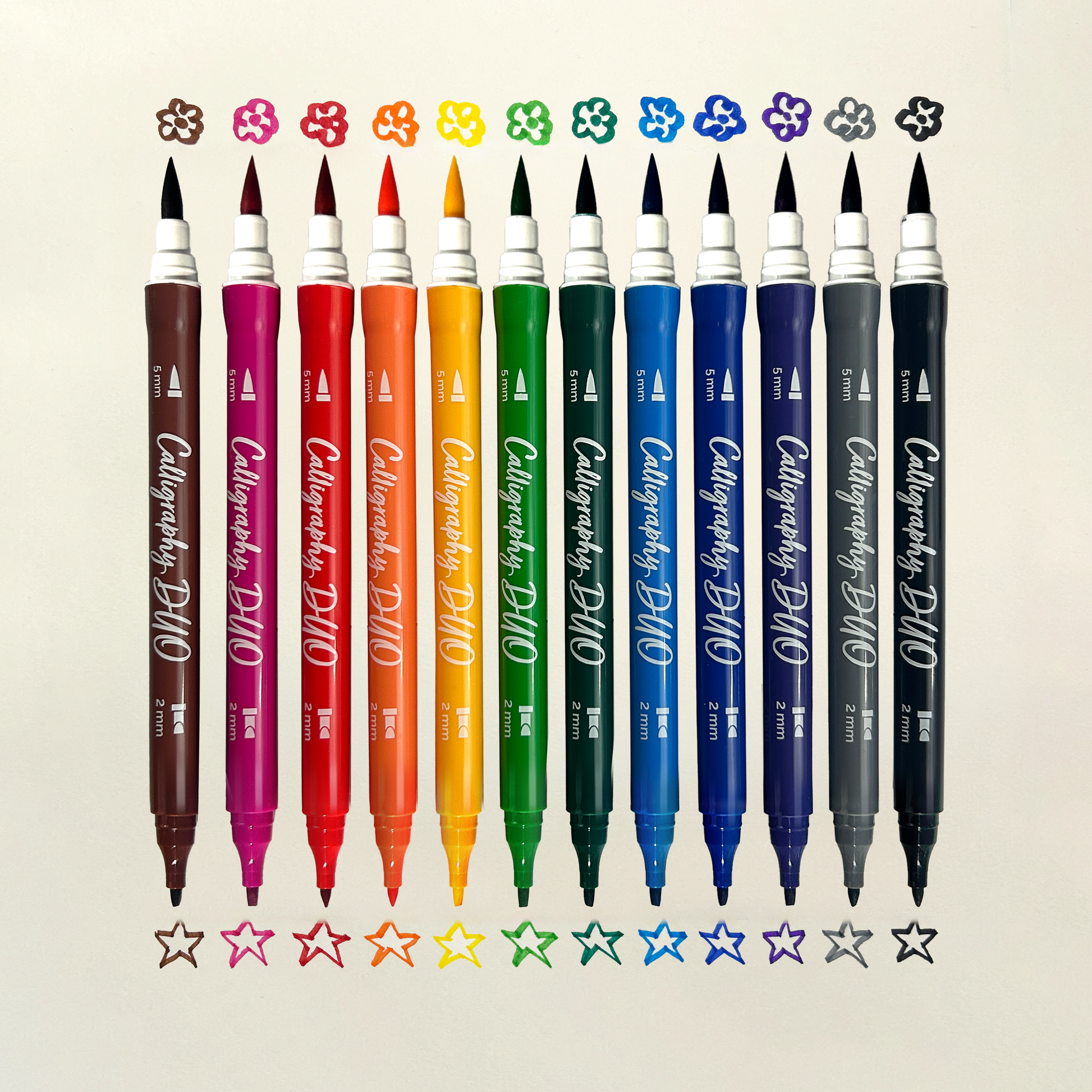 Row of OOLY Calligraphy Duo Double-Ended Markers with chisel and brush tip swatches