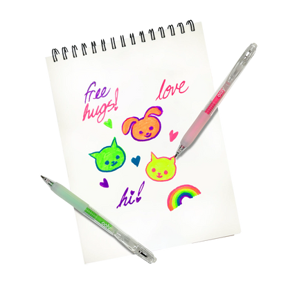 Drawings of cats and a dog with "free hugs" and a rainbow on a white sketchbook made with OOLY Jelly Gloss Neon Multi-Surface Deco Gel Pens