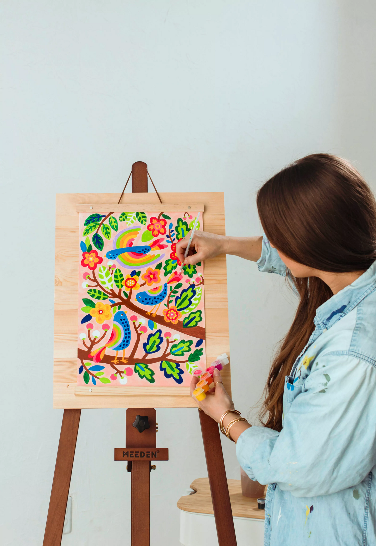 Girl painting canvas on easel from OOLY Paintology Paint-By-Number Canvas Kit - Blue Birds