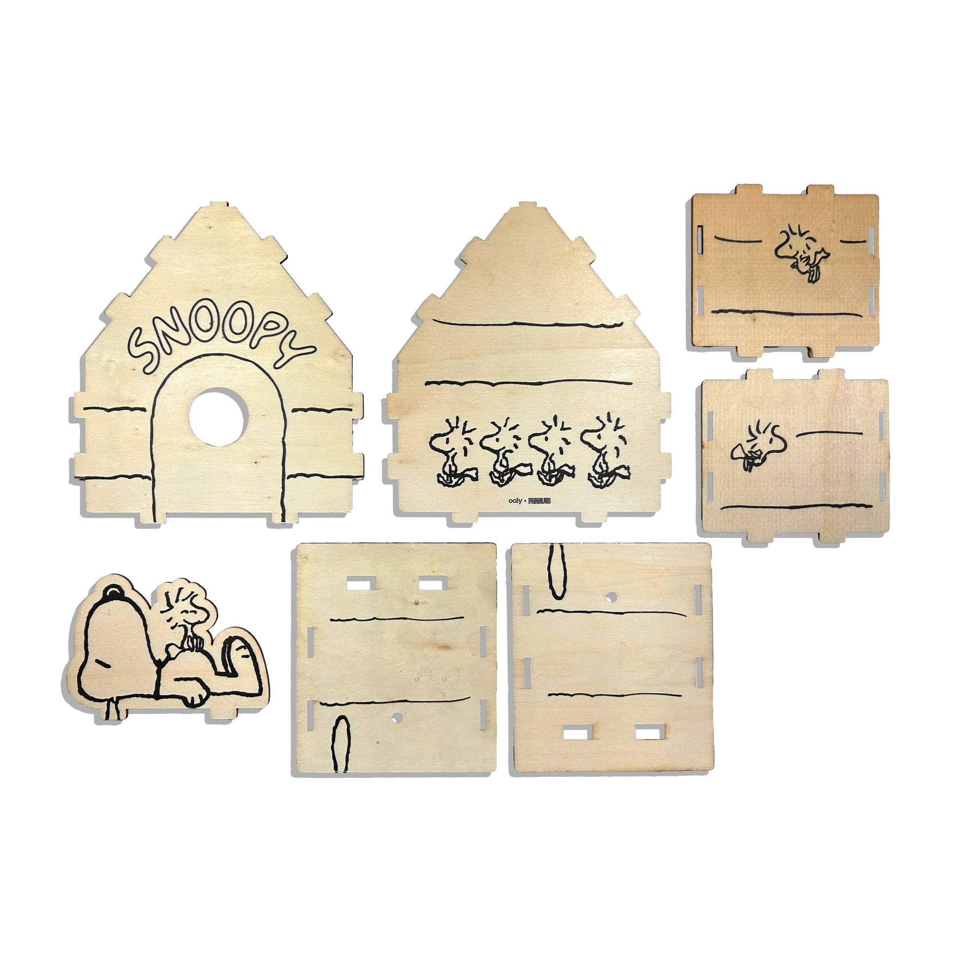 Flat lay of pieces of birdhouse from the OOLY x Peanuts Color-in Wooden Birdhouse Kit