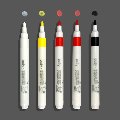 Row of paint markers with caps off and swatches from the OOLY x Peanuts Color-in Wooden Birdhouse Kit
