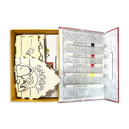 Open set showing markers and bridhouse from OOLY x Peanuts Color-in Wooden Birdhouse Kit