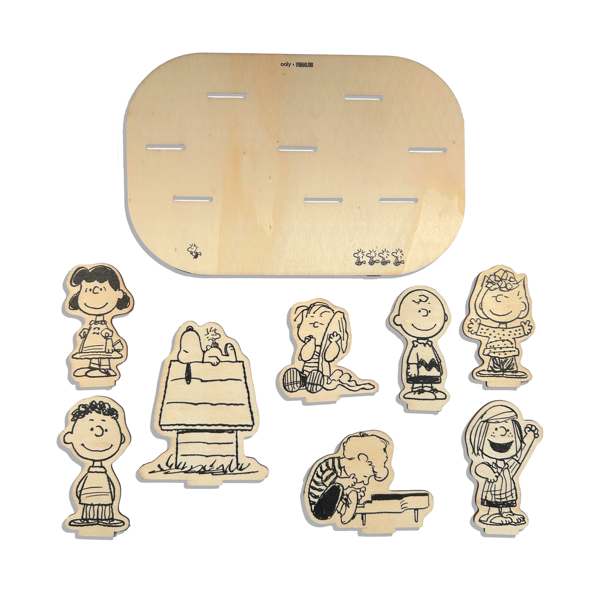 Flat lay of all wooden pieces in the OOLY x Peanuts Color-In Wooden Scene Kit