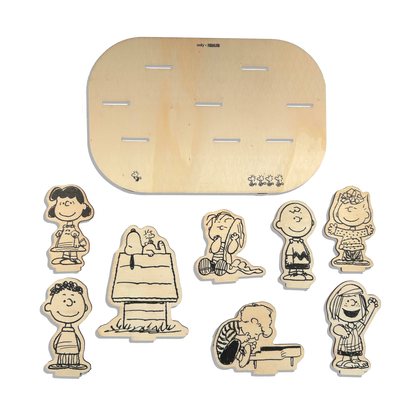 Flat lay of all wooden pieces in the OOLY x Peanuts Color-In Wooden Scene Kit