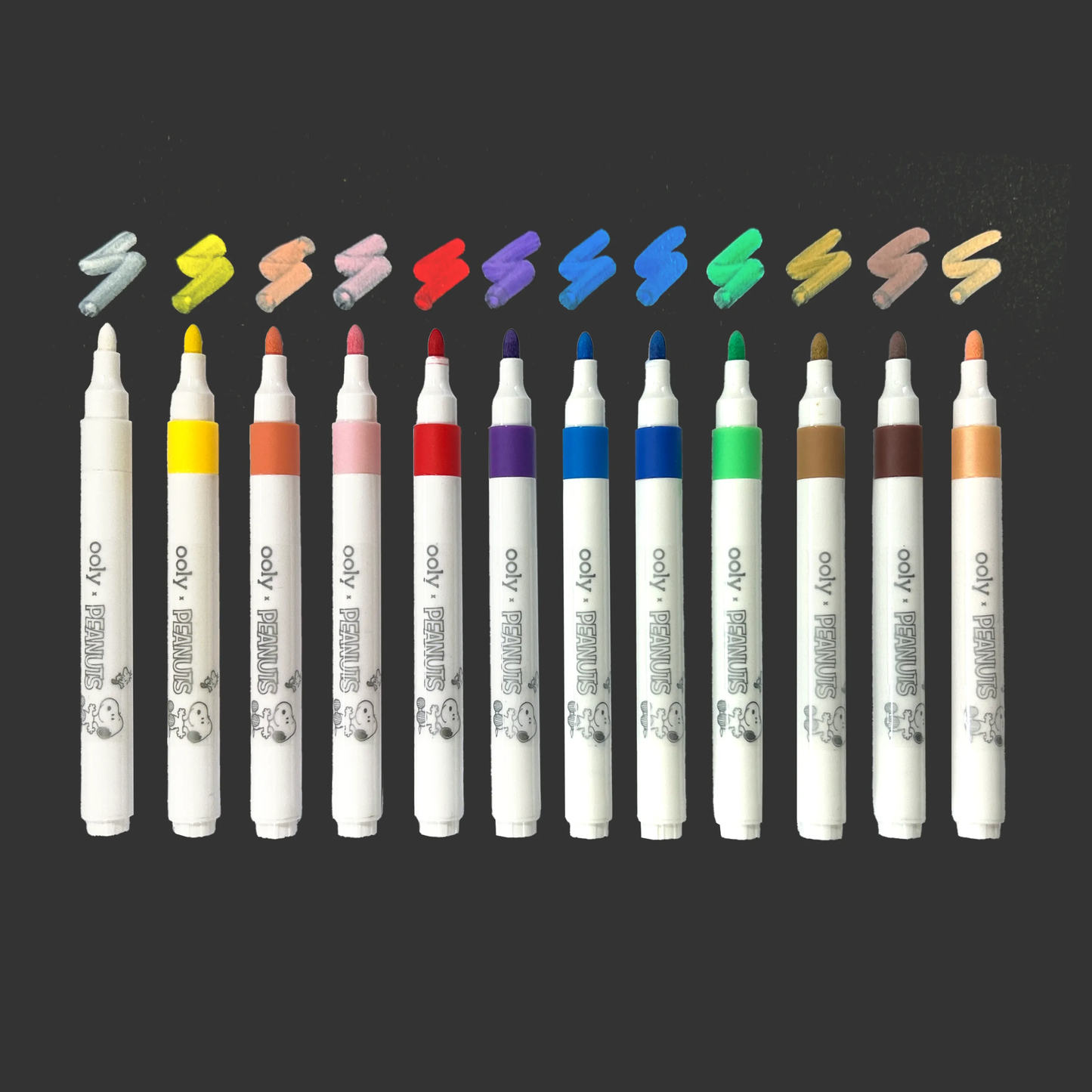 Row of all colored paint markers with swatches from the OOLY x Peanuts Color-In Wooden Scene Kit