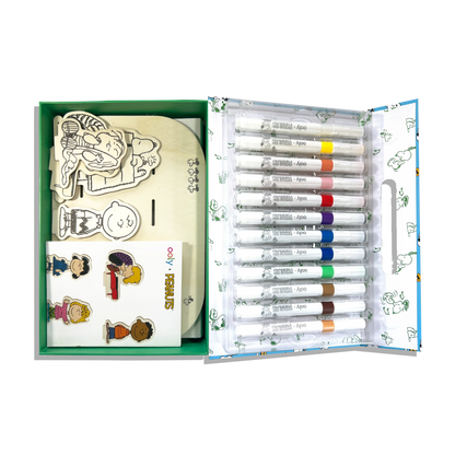 Open set showing contents of the OOLY x Peanuts Color-In Wooden Scene Kit