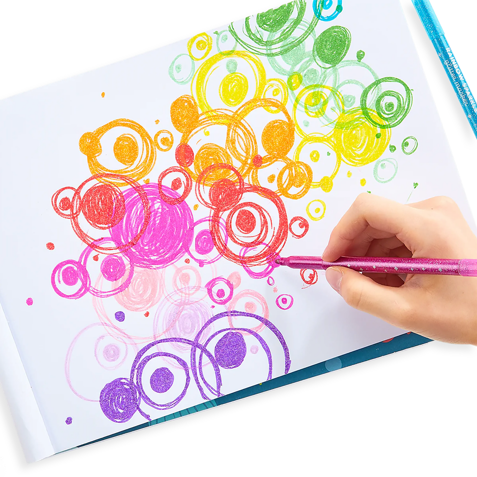 Person coloring rainbowed overlapping circles with OOLY Rainbow Sparkle Glitter Markers