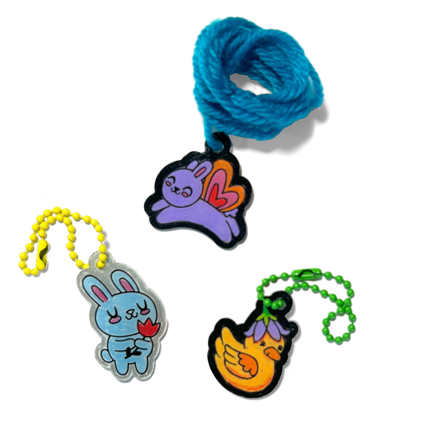 Three completed charms of rabbits and a duck from OOLY Shrink-its! DIY Shrink Art Kit - Garden Pals