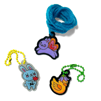 Three completed charms of rabbits and a duck from OOLY Shrink-its! DIY Shrink Art Kit - Garden Pals