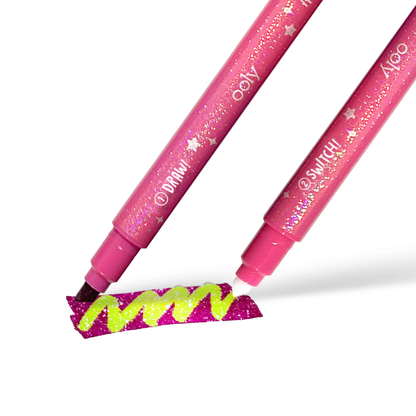Glitter hot pink swatch changing to lime green from OOLY Switch-Eroo Sparkle Glittery Color Changing Markers